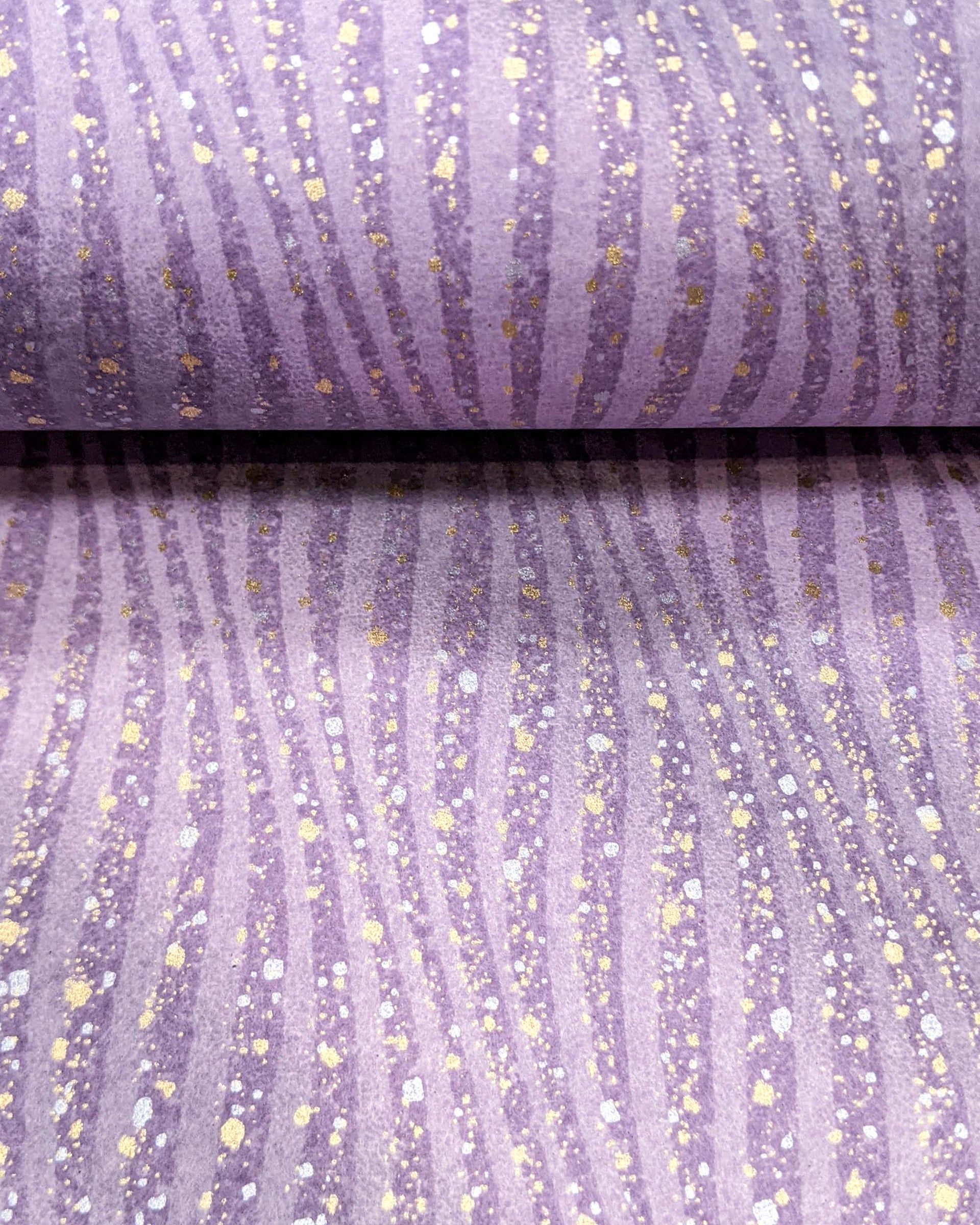Japanese chiyogami paper featuring purple swirls with metallic gold and silver details.