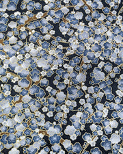 Japanese chiyogami paper featuring blue and gray plum blossom trees with brown branches on a dark blue background with metallic gold details.