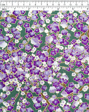 Japanese chiyogami paper featuring purple and white plum blossom trees with brown branches on a purple background with metallic gold details.