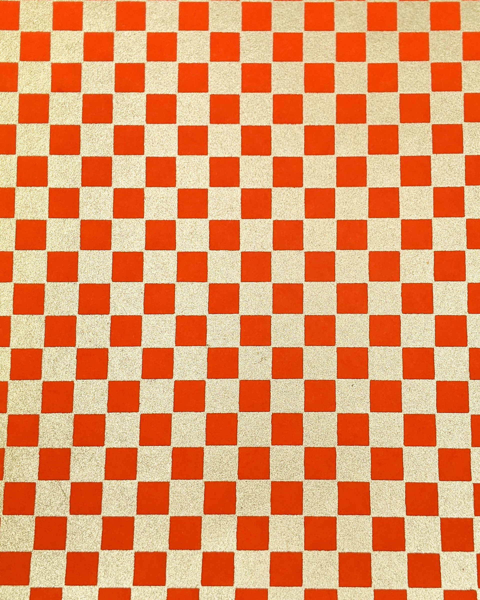 Japanese chiyogami paper featuring a traditional orange and metallic gold ichimatsu (checker) pattern.