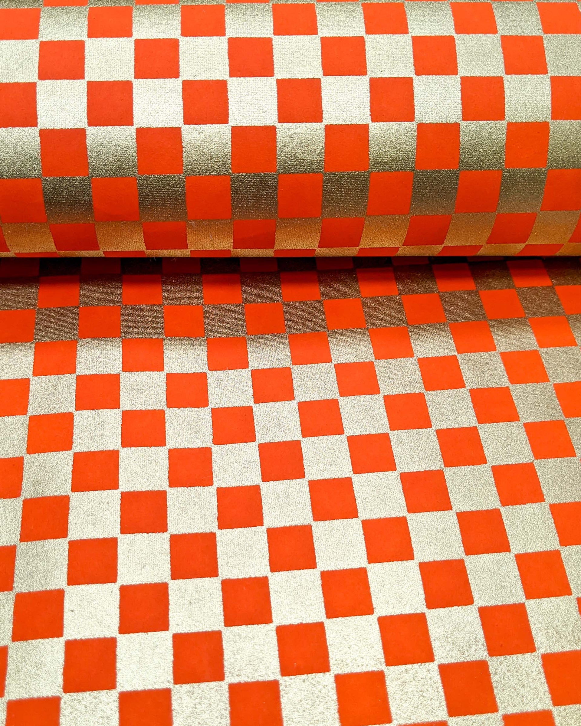 Japanese chiyogami paper featuring a traditional orange and metallic gold ichimatsu (checker) pattern.