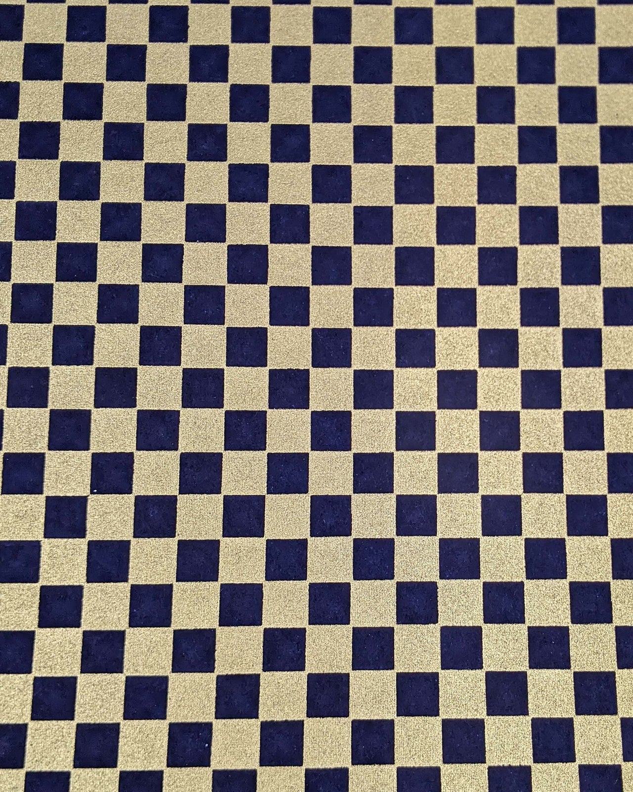 Japanese chiyogami paper featuring a traditional dark blue and metallic gold ichimatsu (checker) pattern.