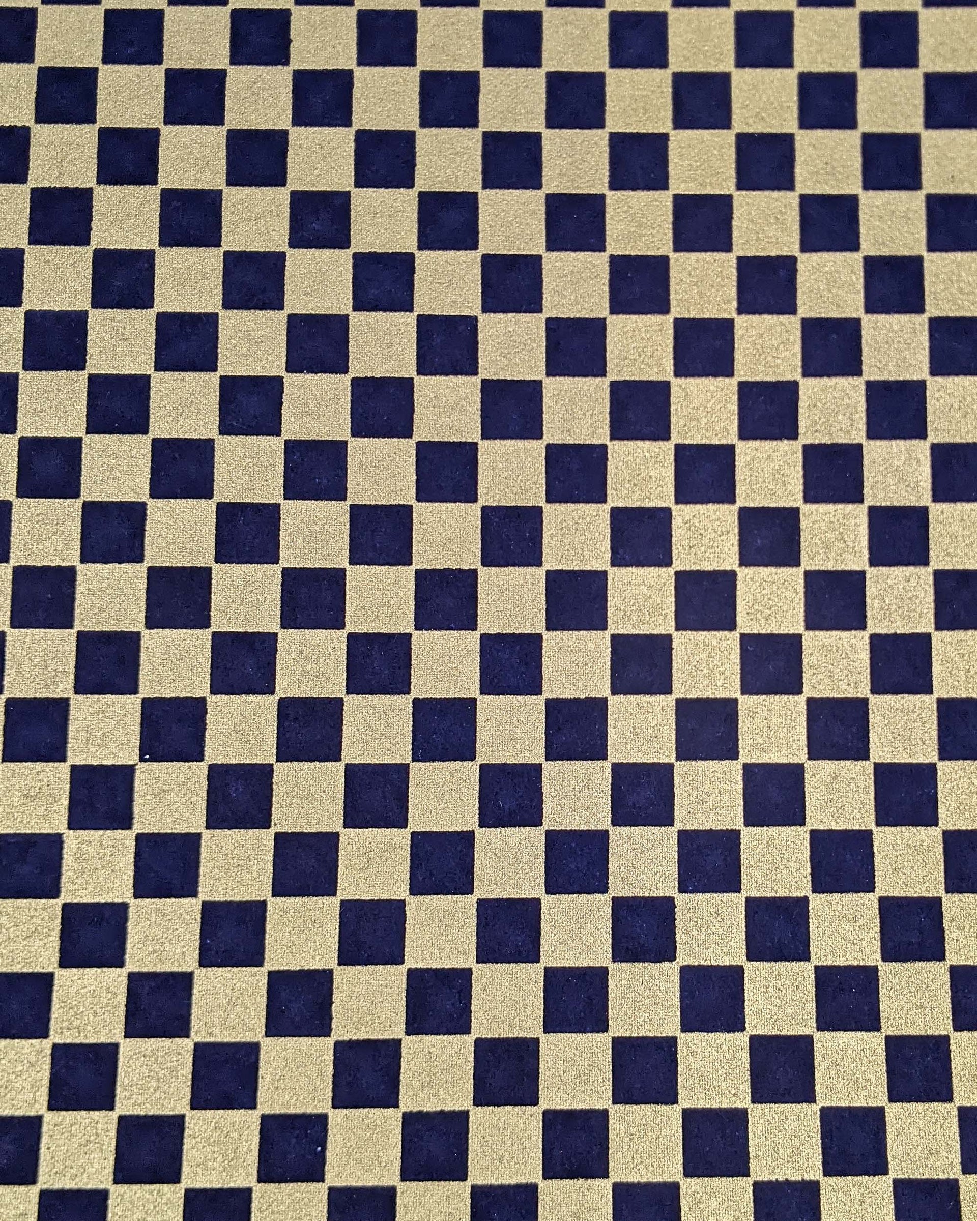 Japanese chiyogami paper featuring a traditional dark blue and metallic gold ichimatsu (checker) pattern.