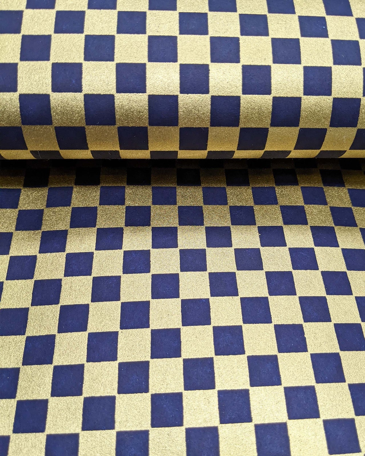 Japanese chiyogami paper featuring a traditional dark blue and metallic gold ichimatsu (checker) pattern.