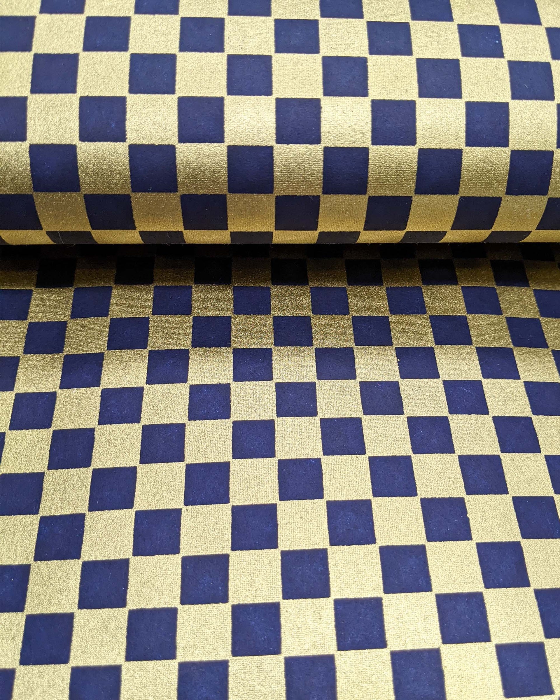 Japanese chiyogami paper featuring a traditional dark blue and metallic gold ichimatsu (checker) pattern.