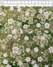 Japanese chiyogami paper featuring green and white cherry and plum blossoms with black branches on a green background with metallic gold details. 