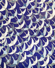 Japanese chiyogami paper featuring blue, gray, and white flying cranes on a blue background with metallic gold details. 