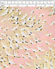Japanese chiyogami paper featuring white flying cranes in a zigzag formation on a light pink background with metallic gold details.