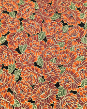 Japanese chiyogami paper featuring large red chrysanthemums with green leaves on a black background with metallic gold details.
