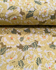Japanese chiyogami paper featuring large yellow chrysanthemums with green leaves on a brown background with metallic gold details.