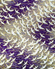 Japanese chiyogami paper featuring white flying cranes in a zigzag formation on a dark purple background with metallic gold details.