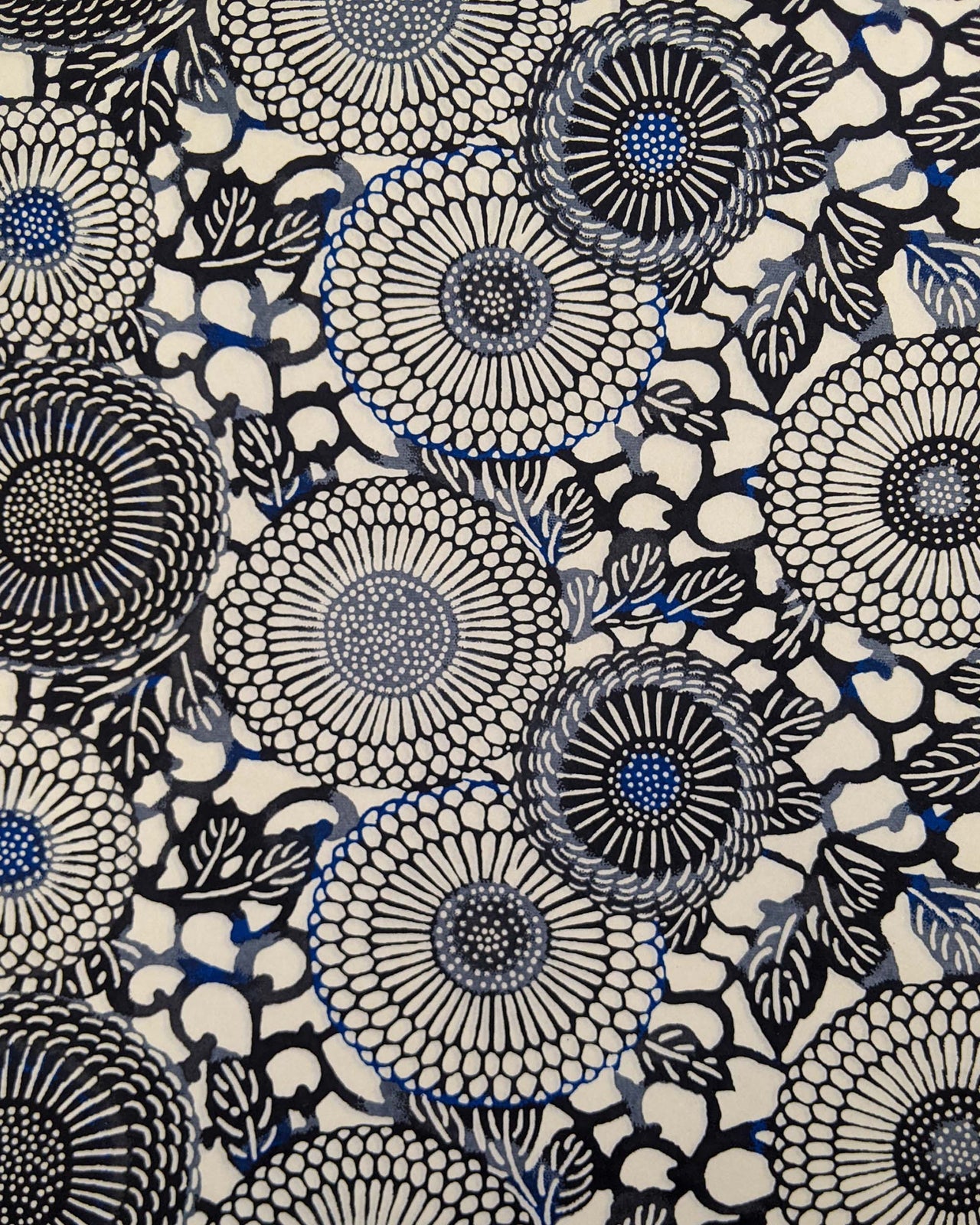 Japanese chiyogami paper featuring large black and gray zinnia flowers with small blue details on a cream background.