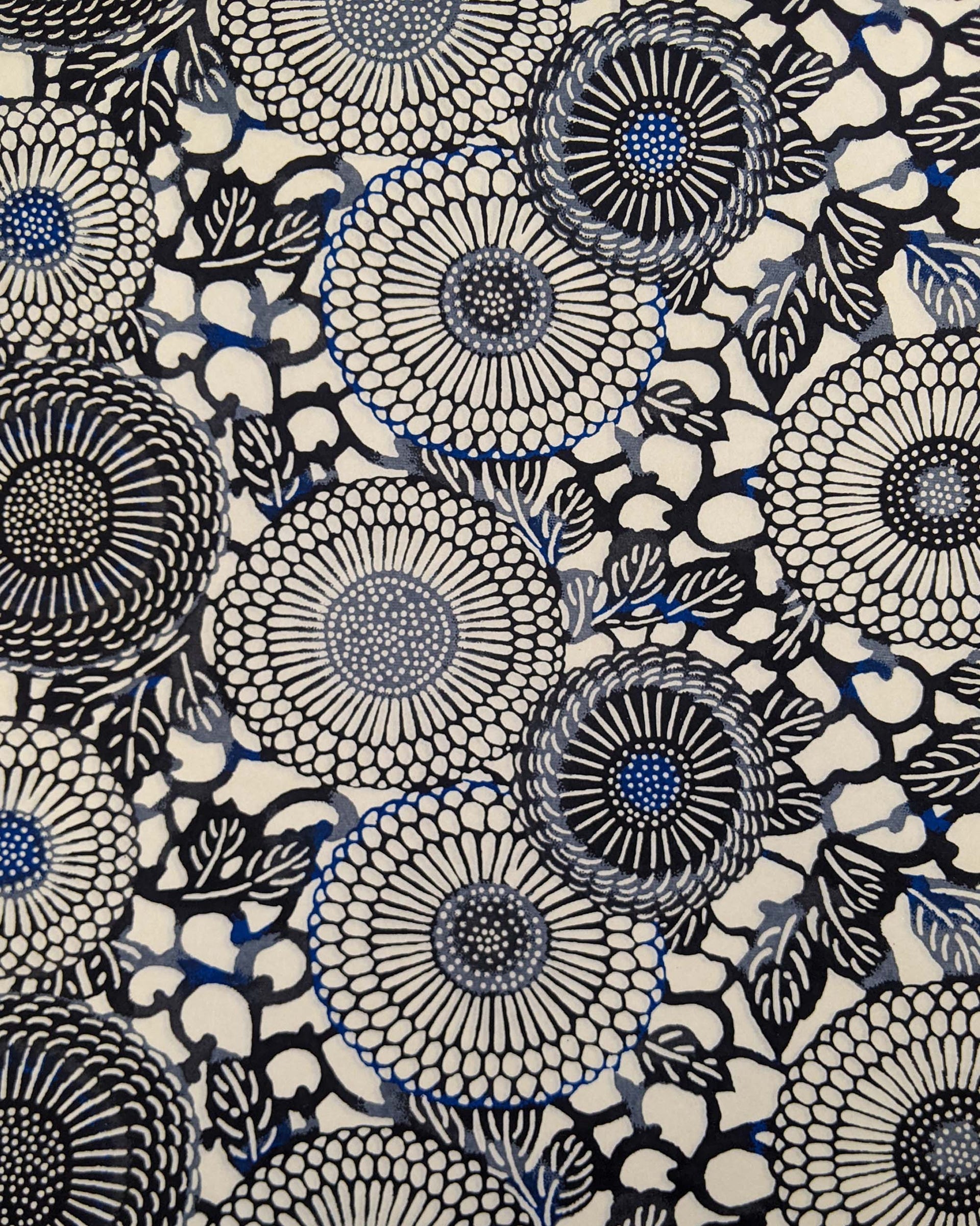 Japanese chiyogami paper featuring large black and gray zinnia flowers with small blue details on a cream background.