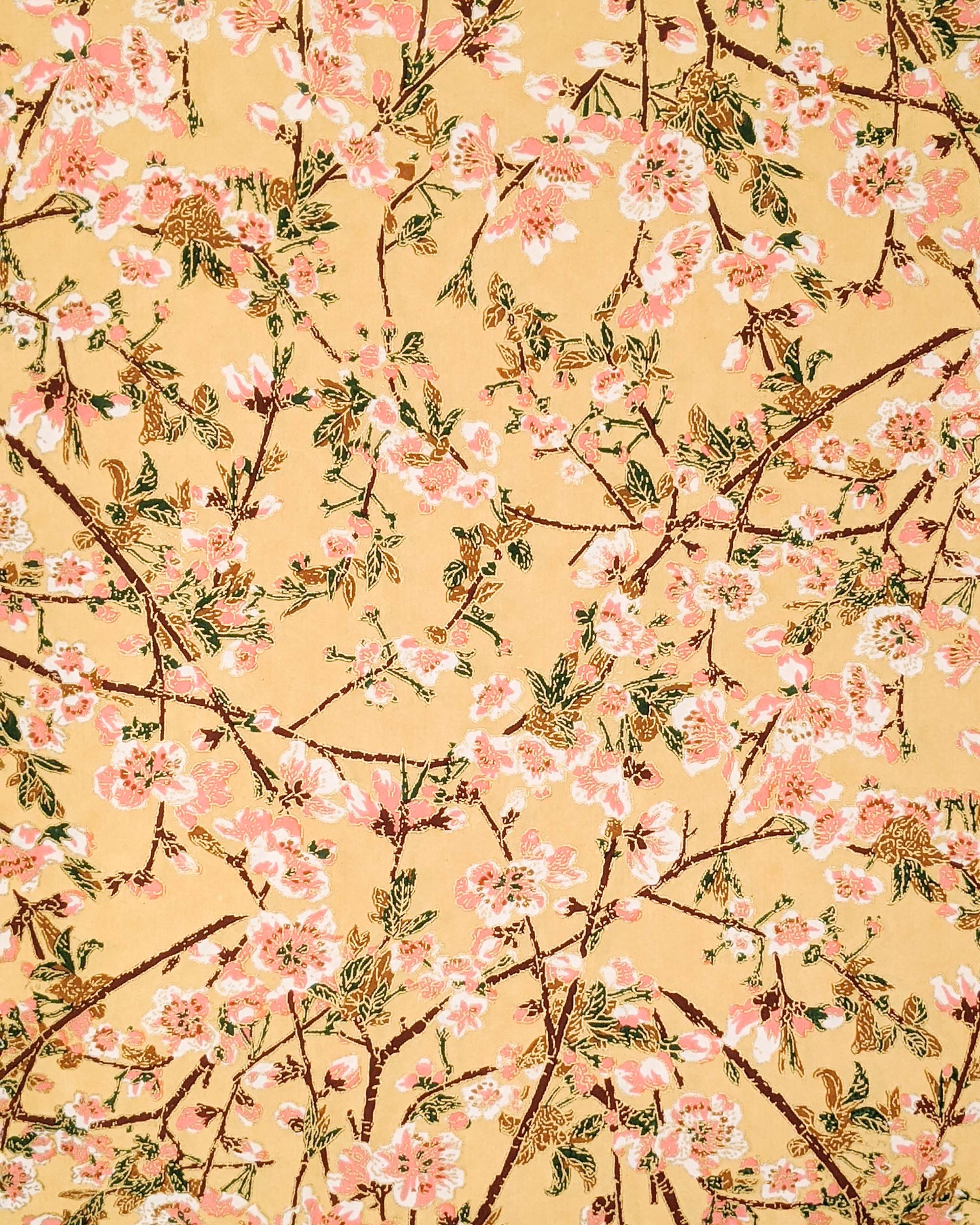 Japanese chiyogami paper featuring pink and white plum blossoms with dark brown branches and green leaves on a beige background with metallic gold details.