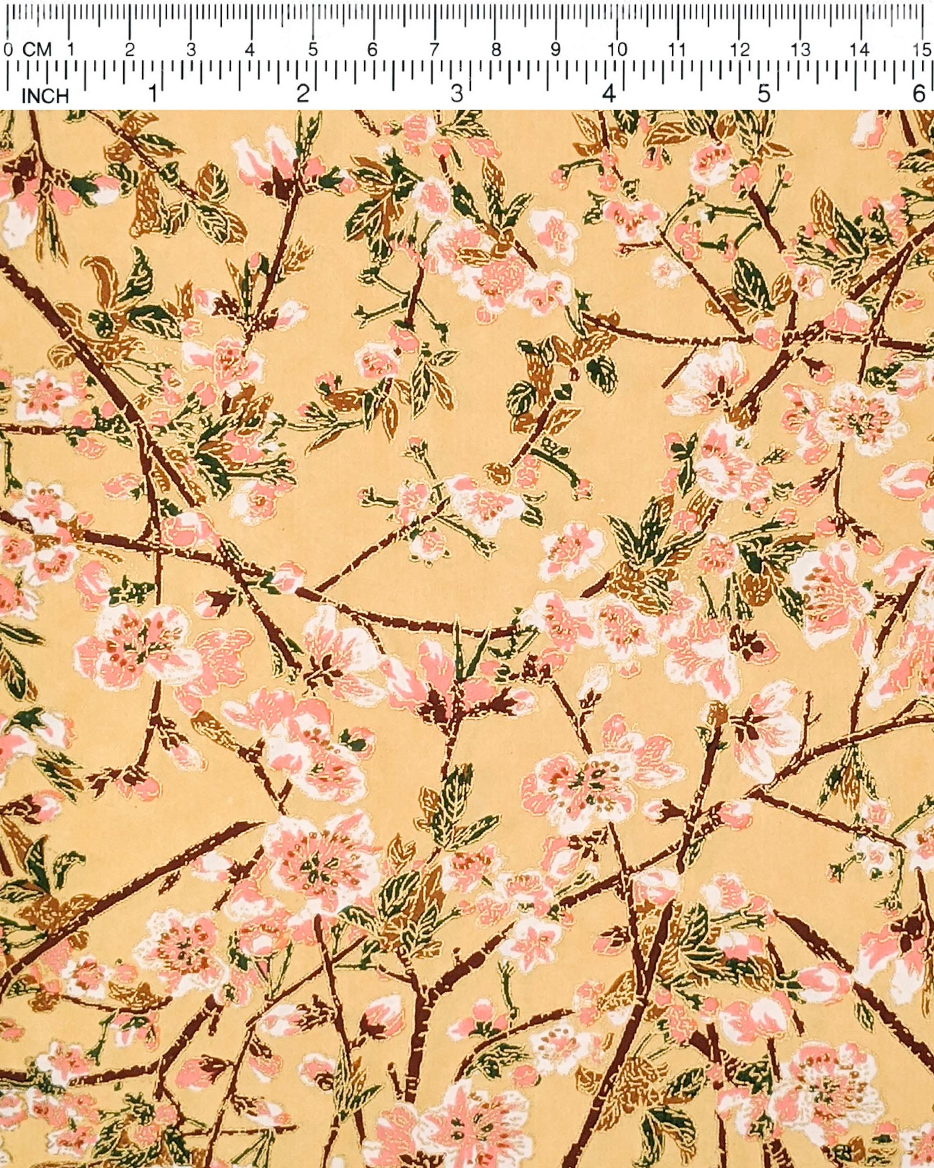 Japanese chiyogami paper featuring pink and white plum blossoms with dark brown branches and green leaves on a beige background with metallic gold details.