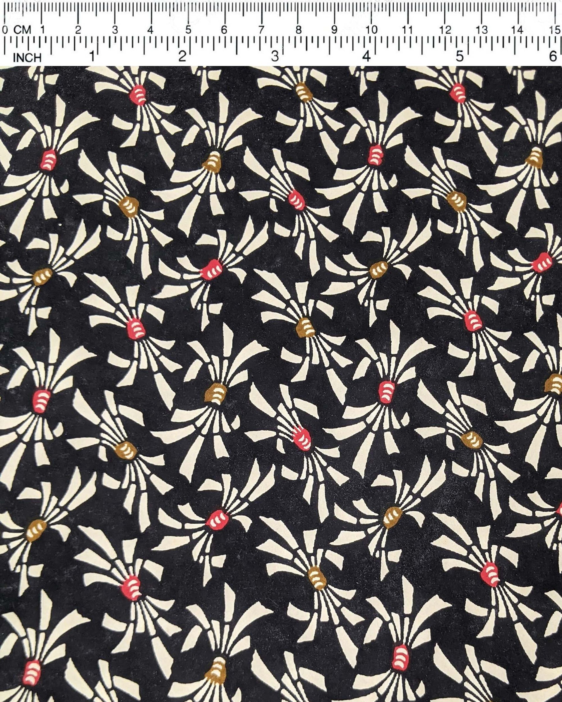 Japanese chiyogami paper featuring cream colored Japanese noshi ribbons with red and brown centers on a black background.