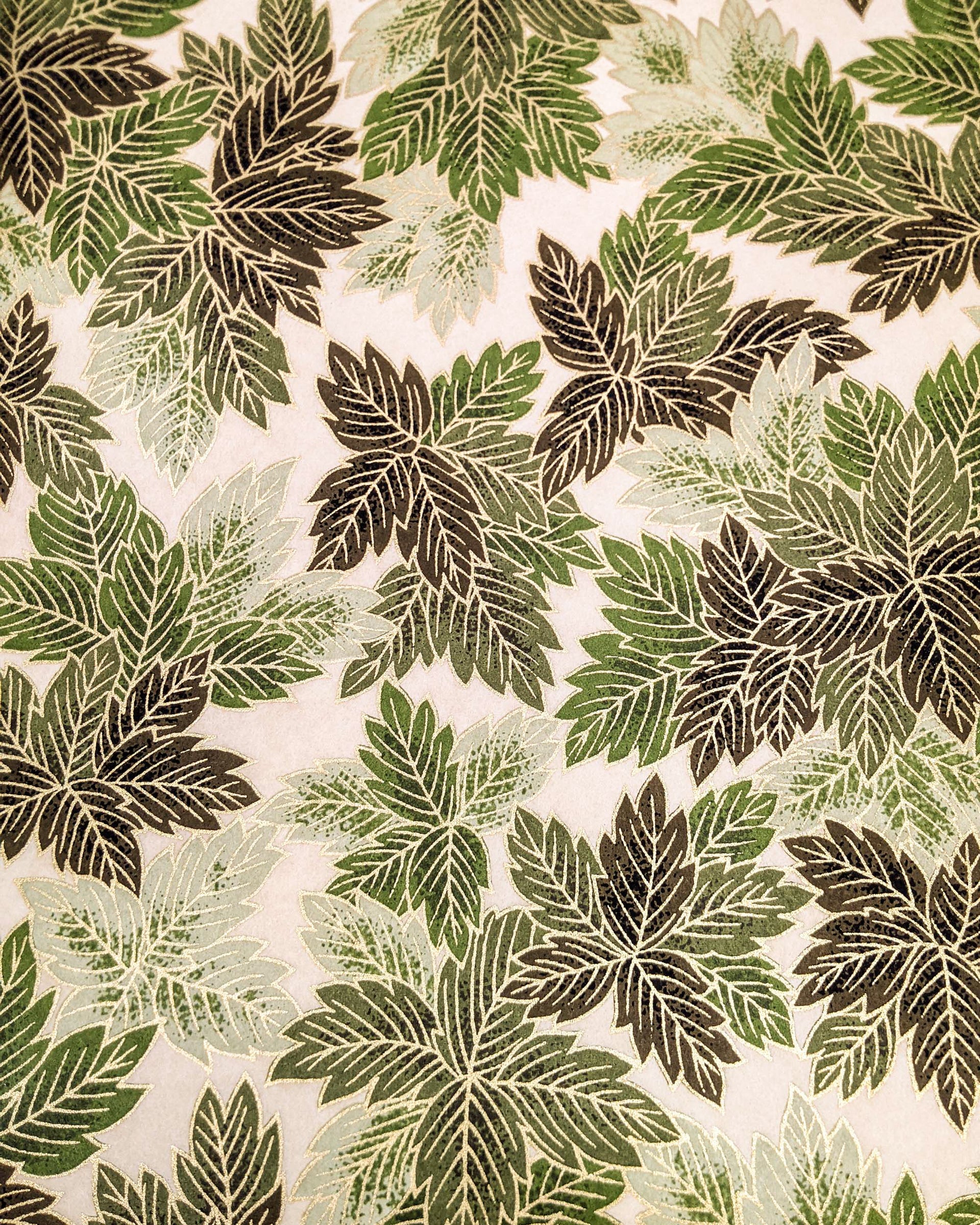 Japanese chiyogami paper featuring large green leaves on a cream background with metallic gold details.