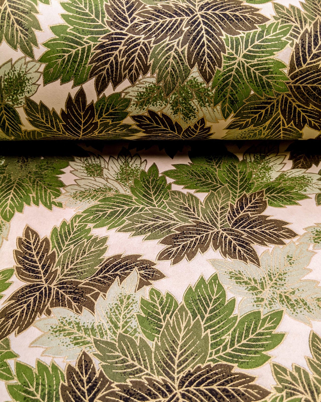 Japanese chiyogami paper featuring large green leaves on a cream background with metallic gold details.