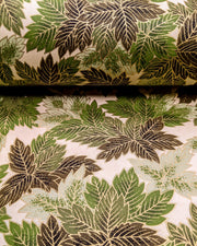 Japanese chiyogami paper featuring large green leaves on a cream background with metallic gold details.