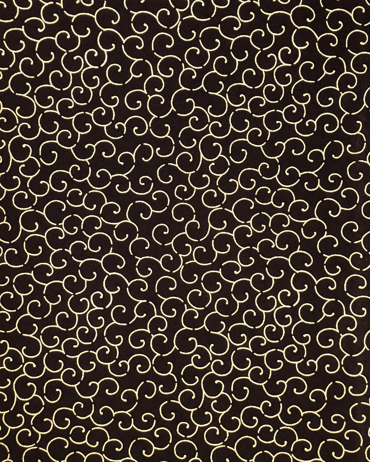 Japanese chiyogami paper featuring a metallic gold traditional karakusa design on a black background.