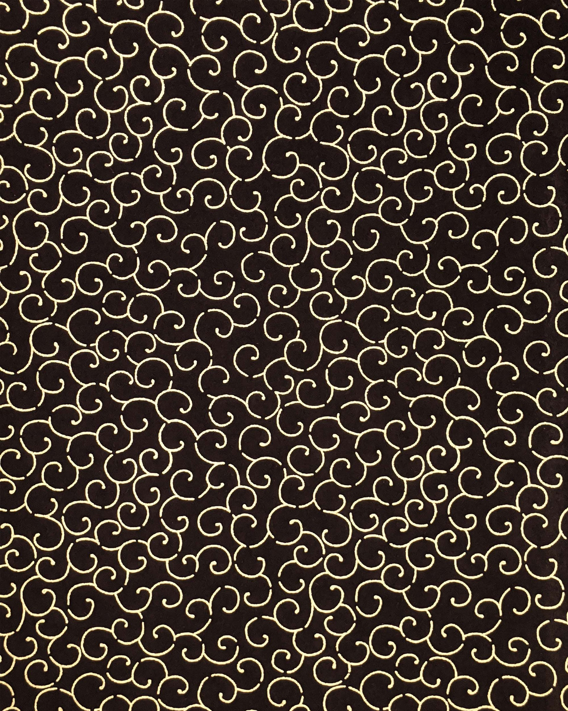 Japanese chiyogami paper featuring a metallic gold traditional karakusa design on a black background.