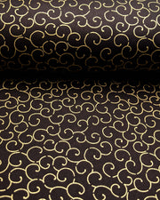 Japanese chiyogami paper featuring a metallic gold traditional karakusa design on a black background.
