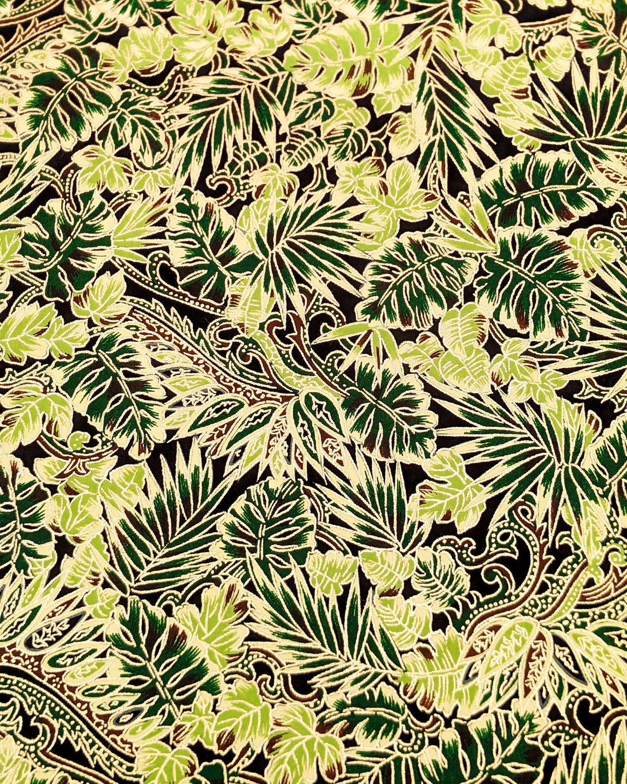 Japanese chiyogami paper featuring green and brown frond leaves on a black background with metallic gold details.