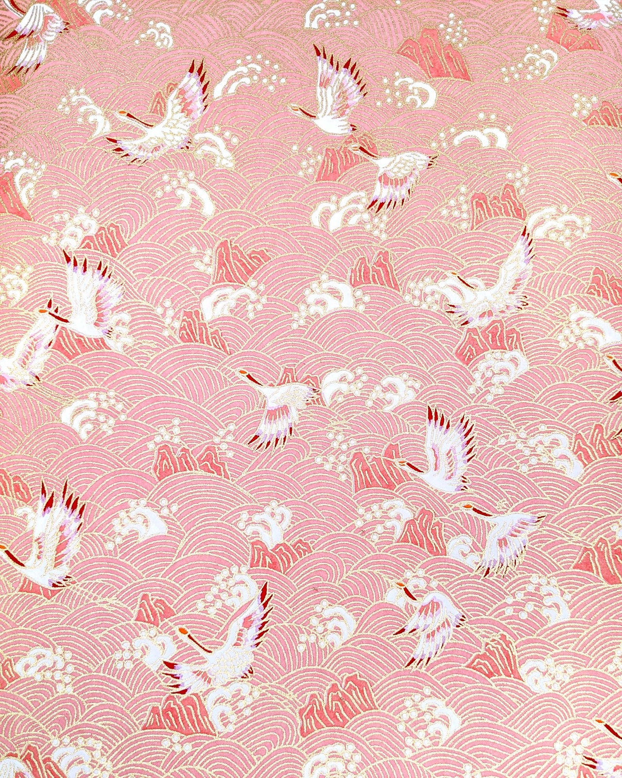 Japanese chiyogami paper featuring white and pink cranes flying over a pink wave background with metallic gold details.