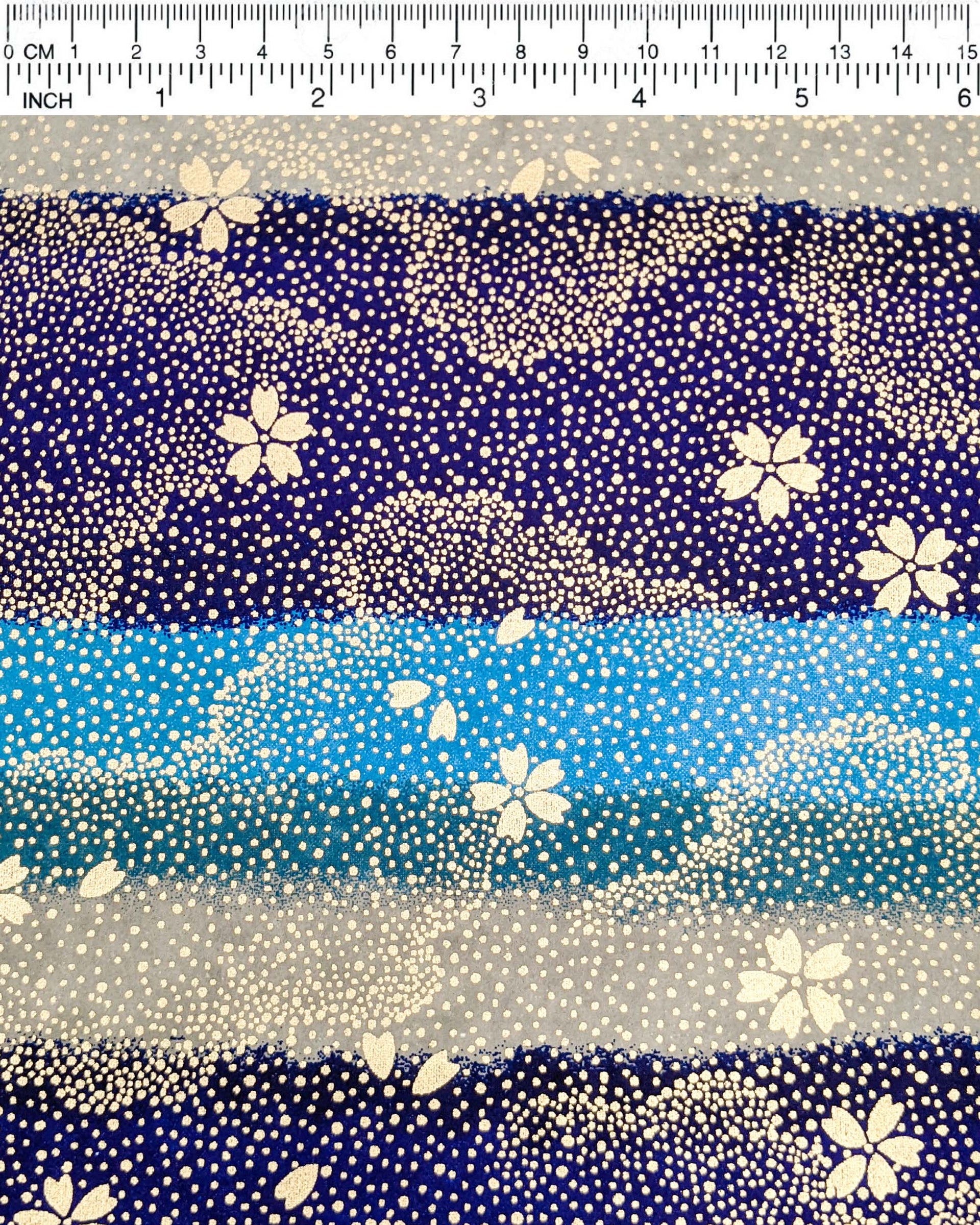Japanese chiyogami paper featuring gold cherry blossoms on a blue and gray striped background with metallic gold details.