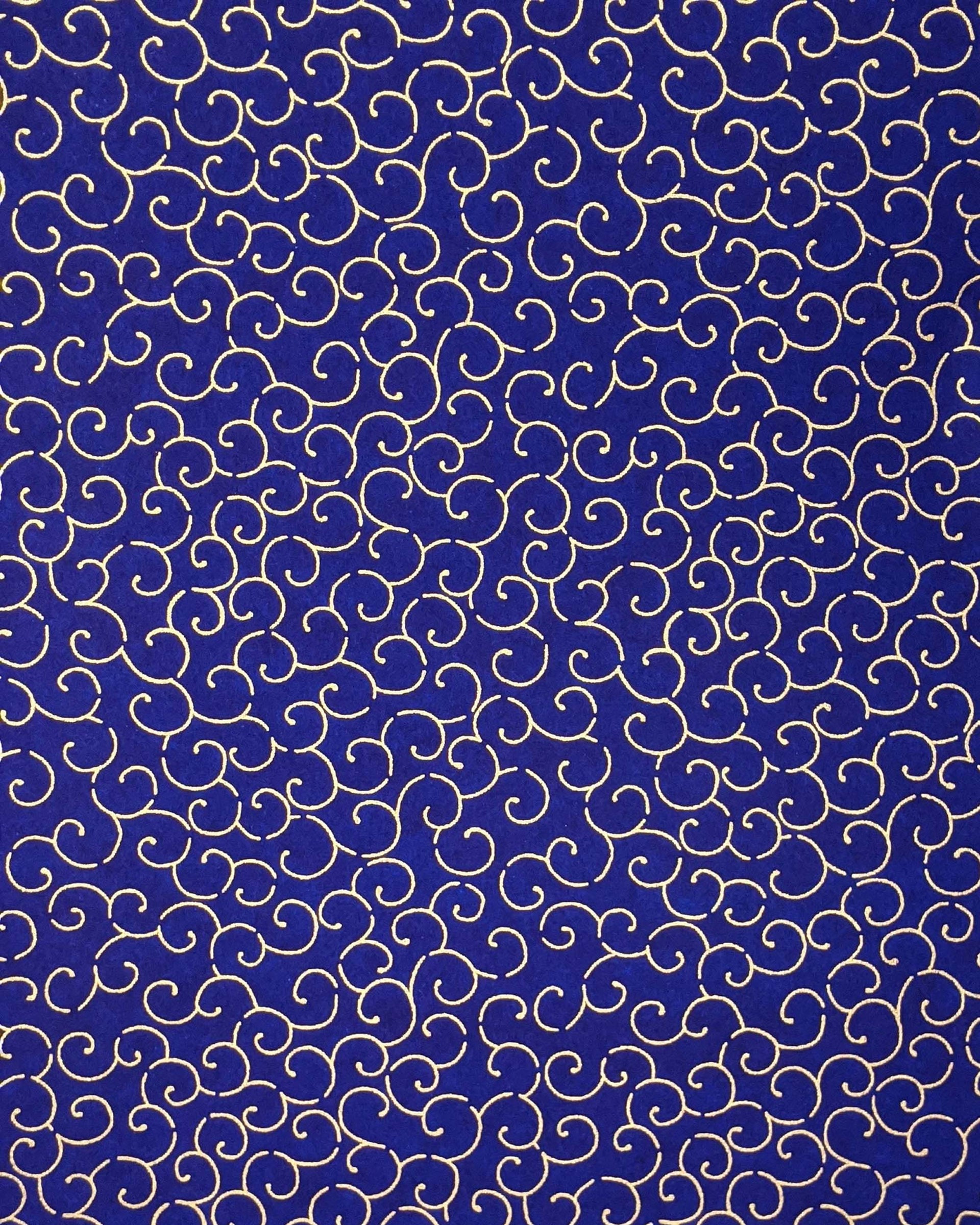 Japanese chiyogami paper featuring a metallic gold traditional karakusa design on a dark blue background.