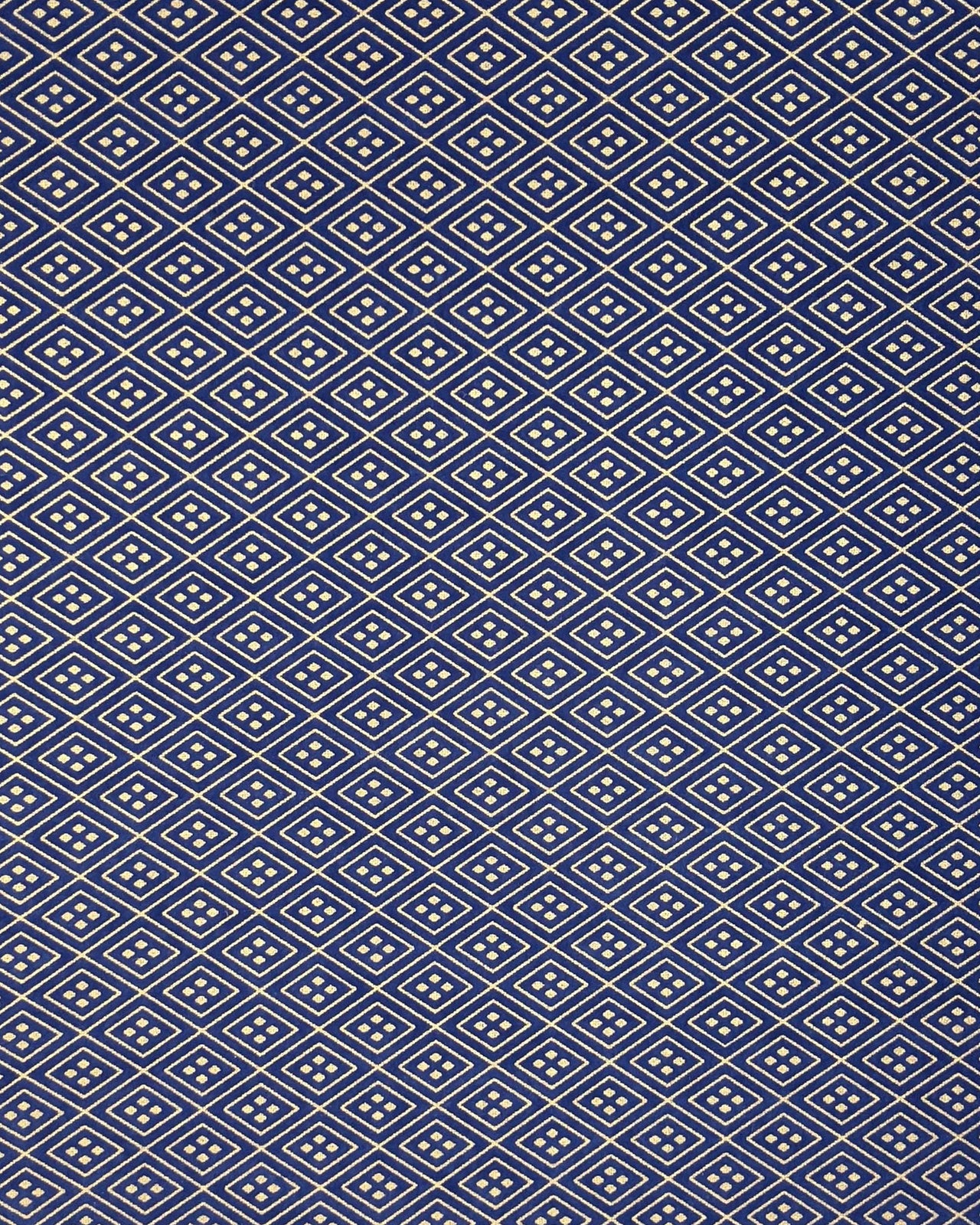 Japanese chiyogami paper featuring a metallic gold traditional hishi design on a dark blue background. 