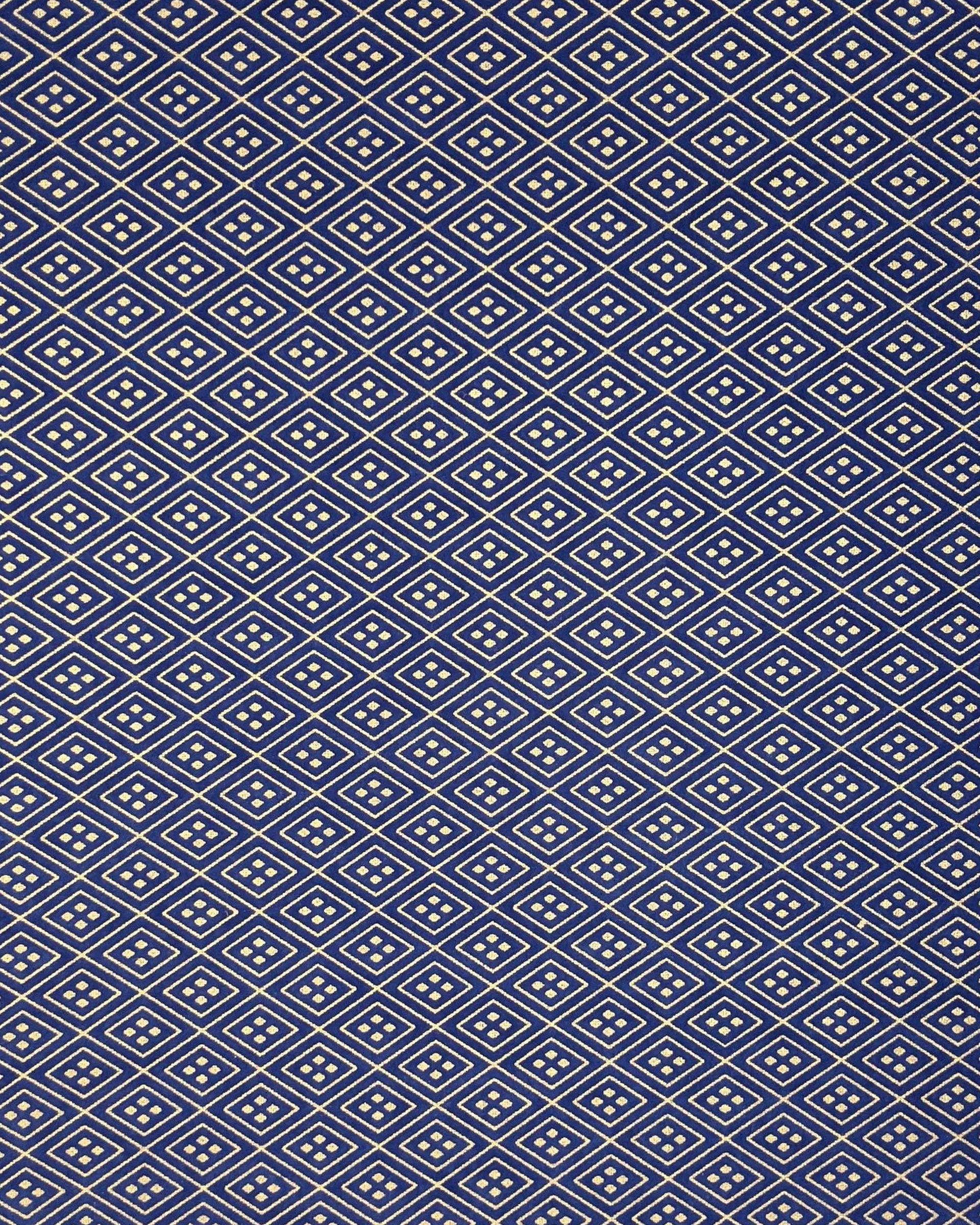 Japanese chiyogami paper featuring a metallic gold traditional hishi design on a dark blue background. 