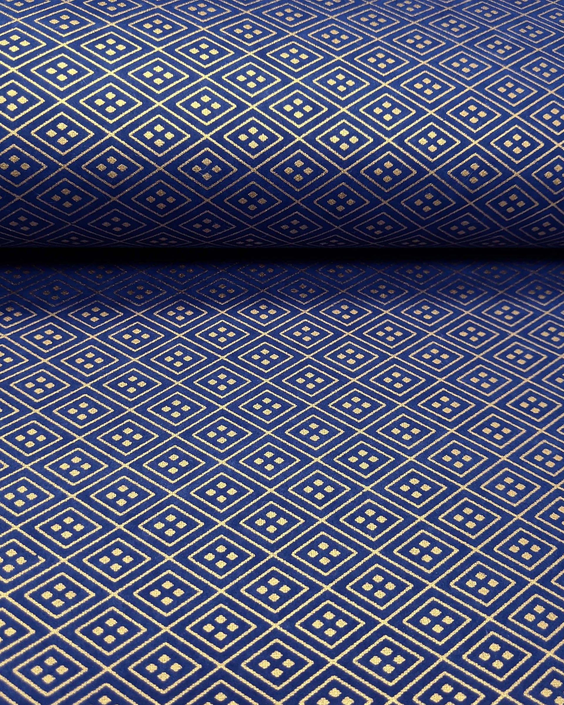 Japanese chiyogami paper featuring a metallic gold traditional hishi design on a dark blue background. 