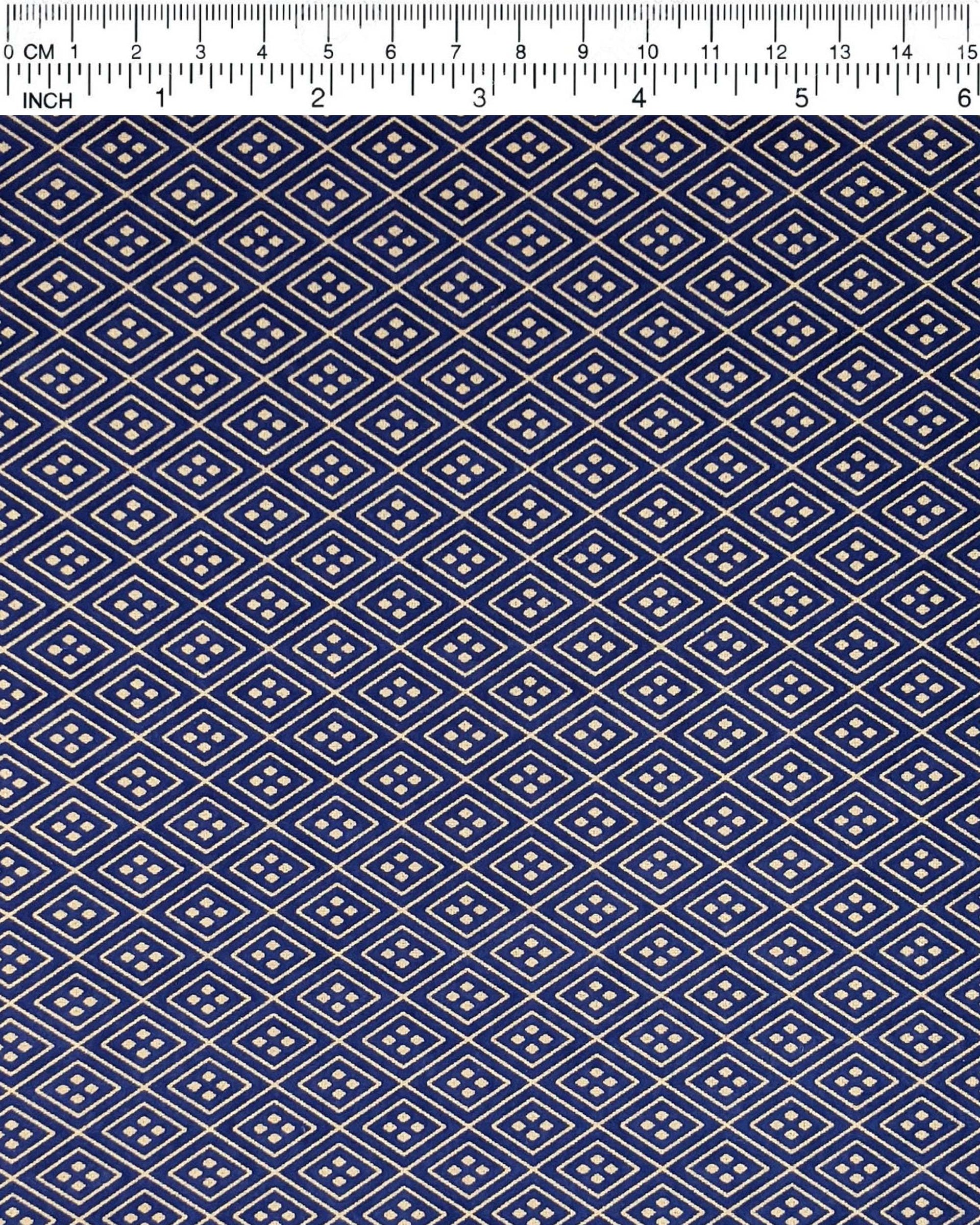 Japanese chiyogami paper featuring a metallic gold traditional hishi design on a dark blue background. 