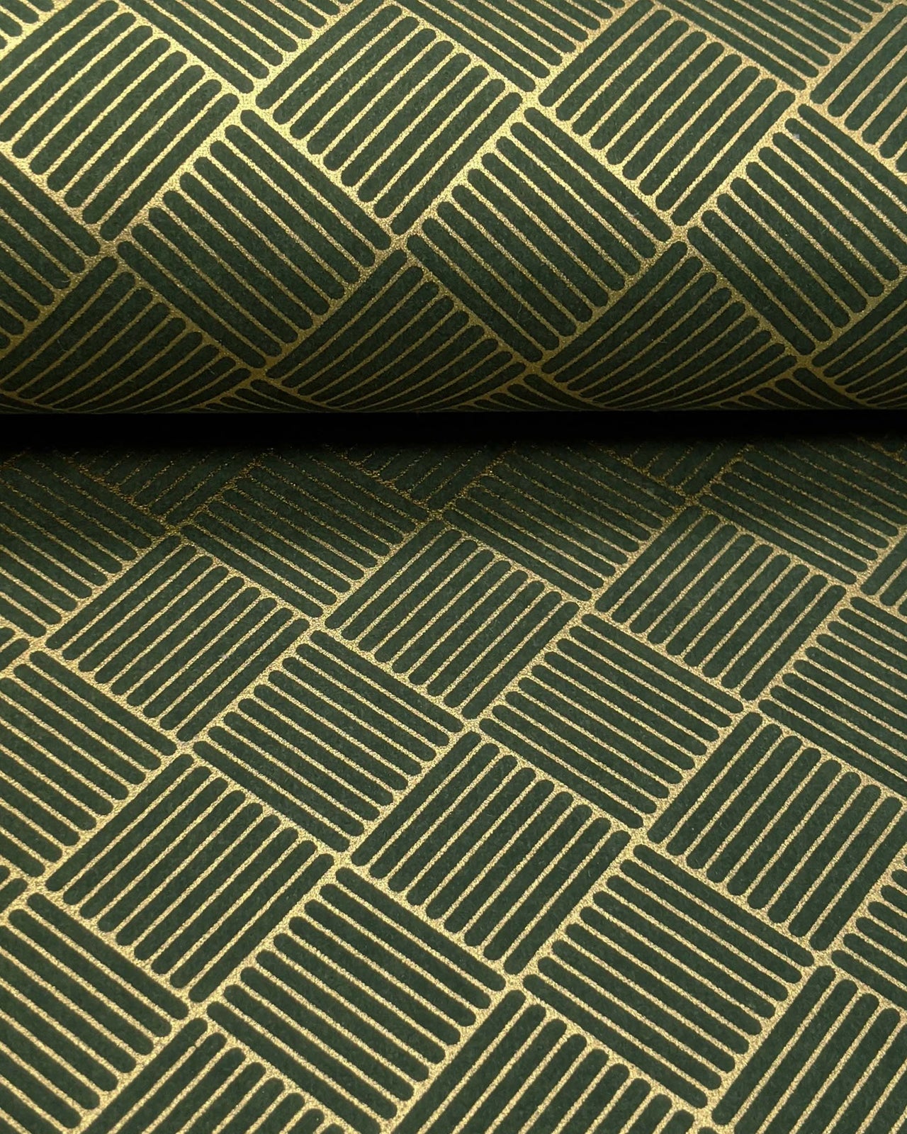 Japanese chiyogami paper featuring a metallic gold traditional san kuzushi (crosshatch) design on a dark green background.