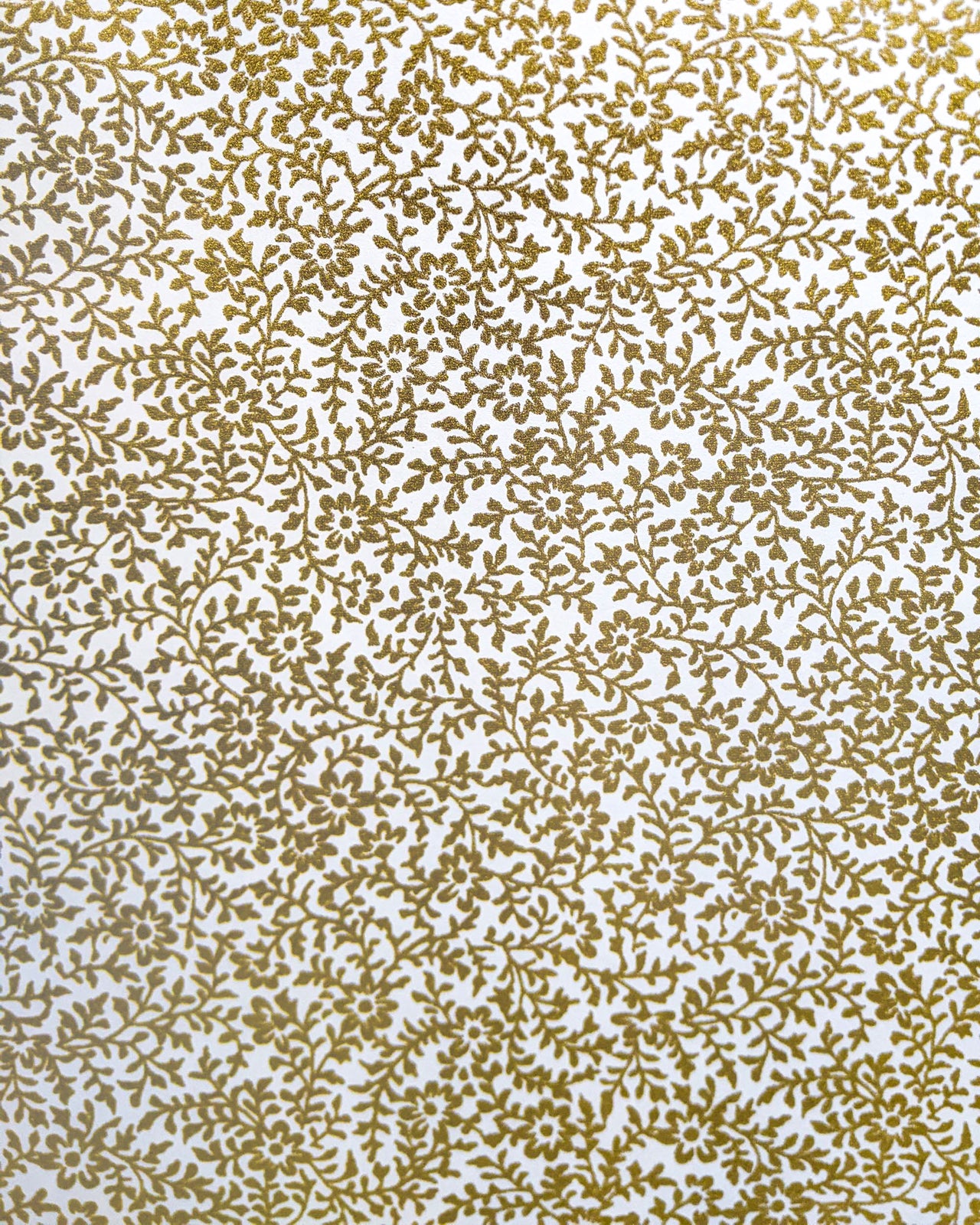 Japanese chiyogami paper featuring a metallic gold floral motif on a white background.