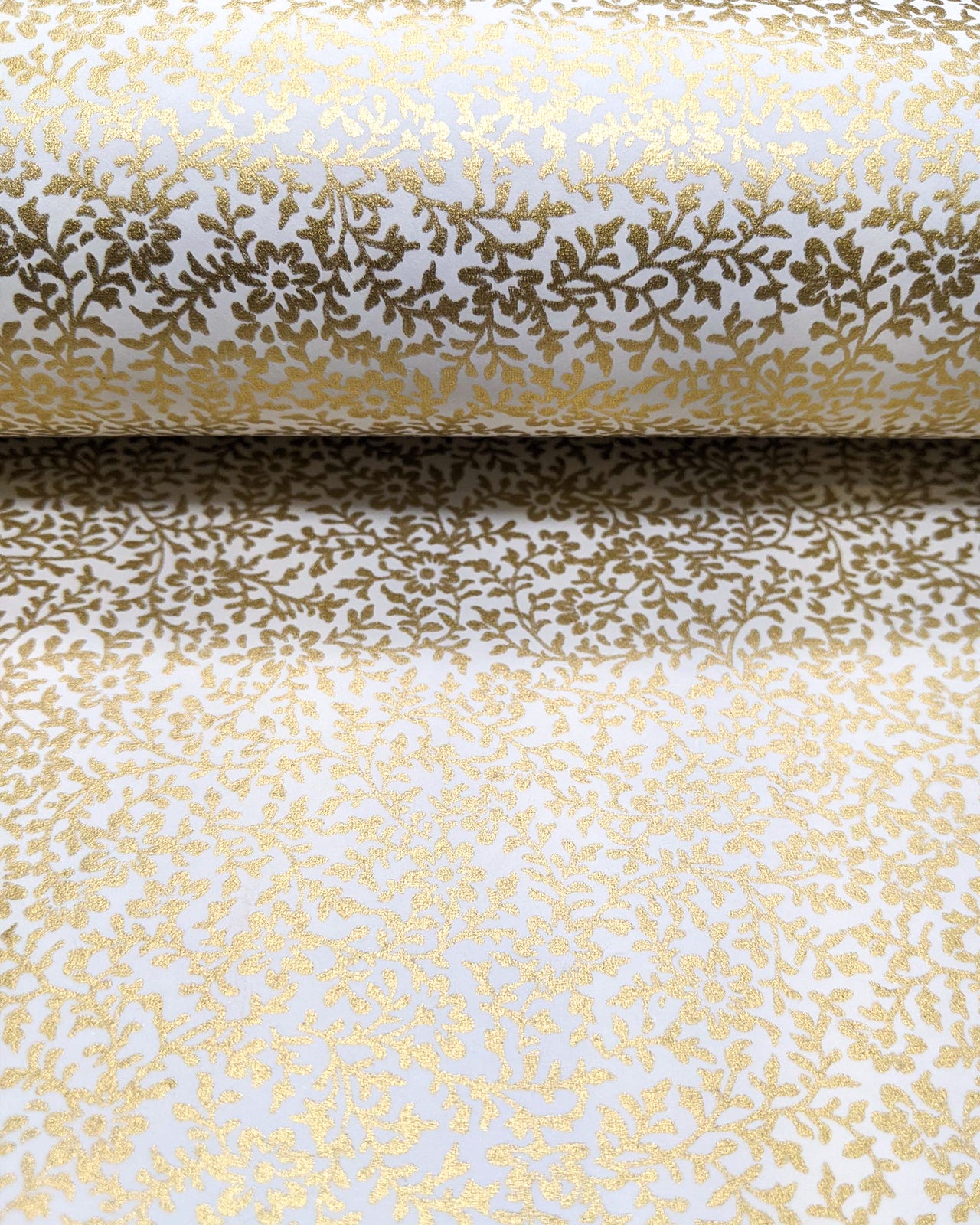 Japanese chiyogami paper featuring a metallic gold floral motif on a white background.