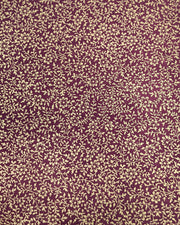Japanese chiyogami paper featuring a metallic gold floral motif on a purple background.