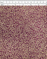 Japanese chiyogami paper featuring a metallic gold floral motif on a purple background.