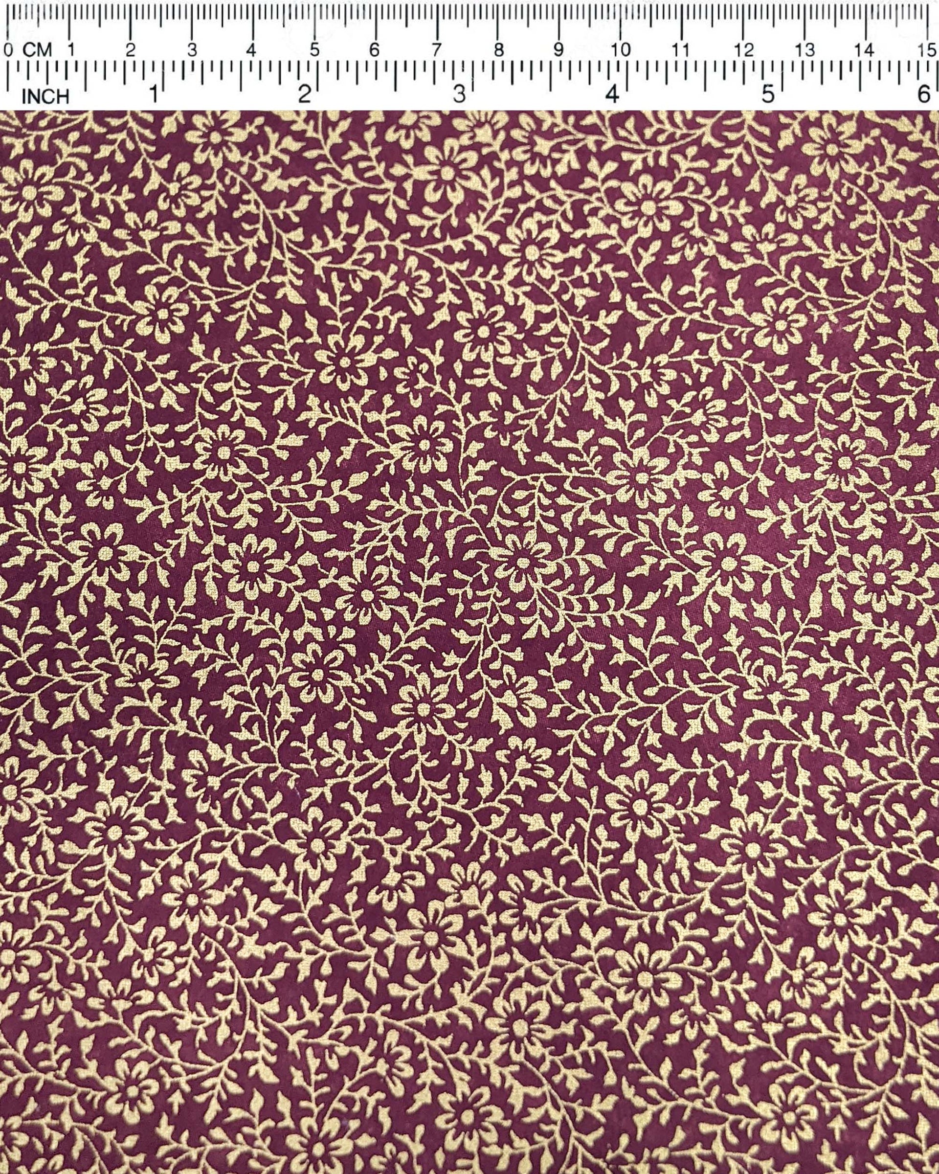 Japanese chiyogami paper featuring a metallic gold floral motif on a purple background.