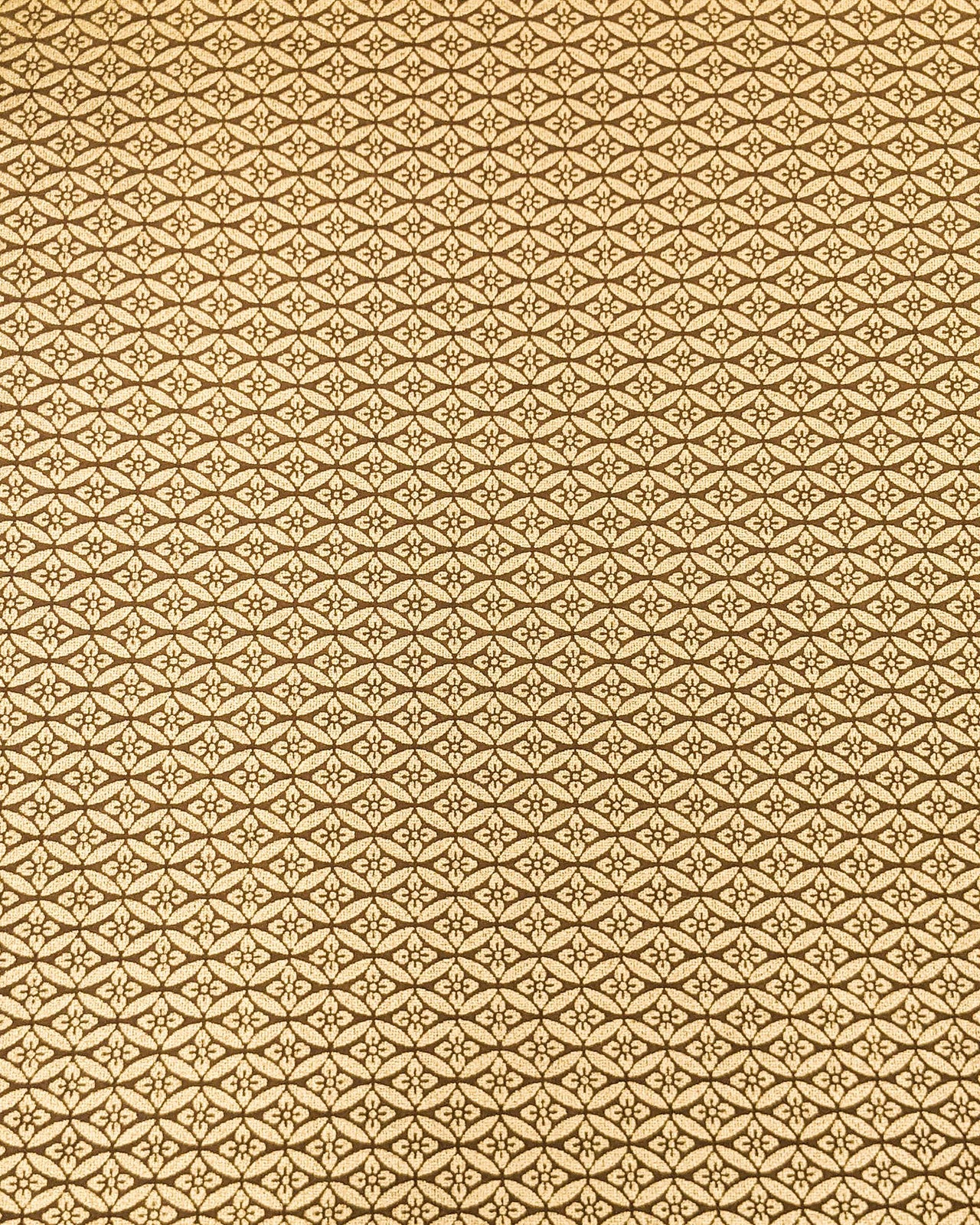 Japanese chiyogami paper featuring a metallic gold oval shippo design with a floral motif in the center.