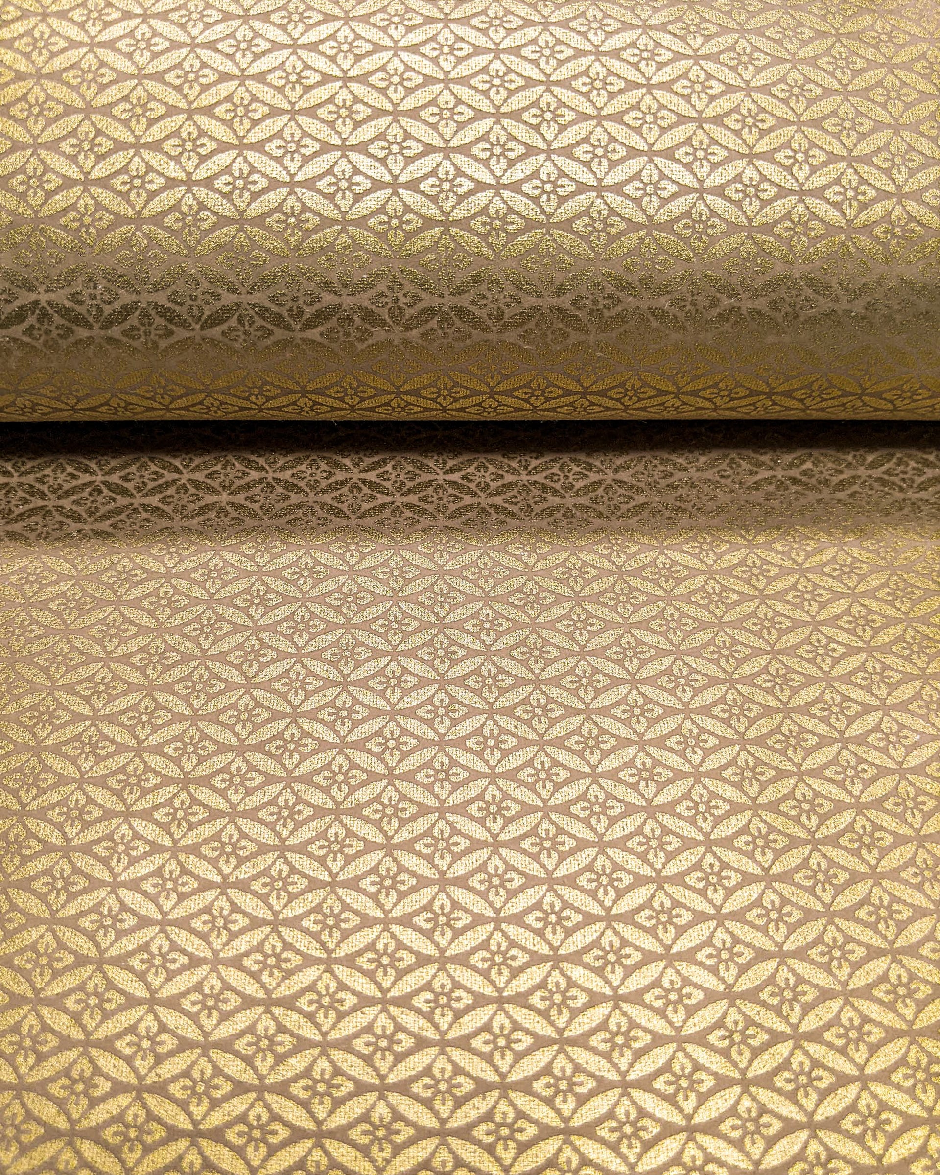 Japanese chiyogami paper featuring a metallic gold oval shippo design with a floral motif in the center.