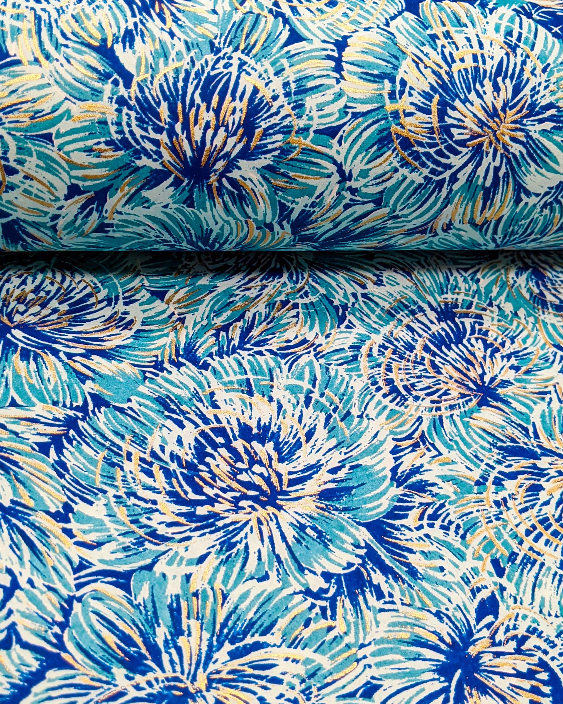 Japanese chiyogami paper featuring large blue chrysanthemums on a dark blue background with metallic gold details.