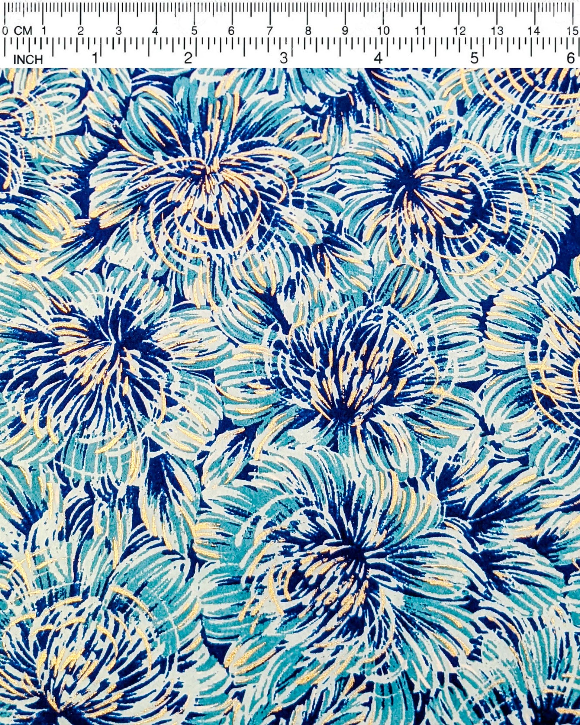 Japanese chiyogami paper featuring large blue chrysanthemums on a dark blue background with metallic gold details.