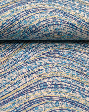 Japanese chiyogami paper featuring metallic gold and dark blue swirls on a light blue and white speckled background.