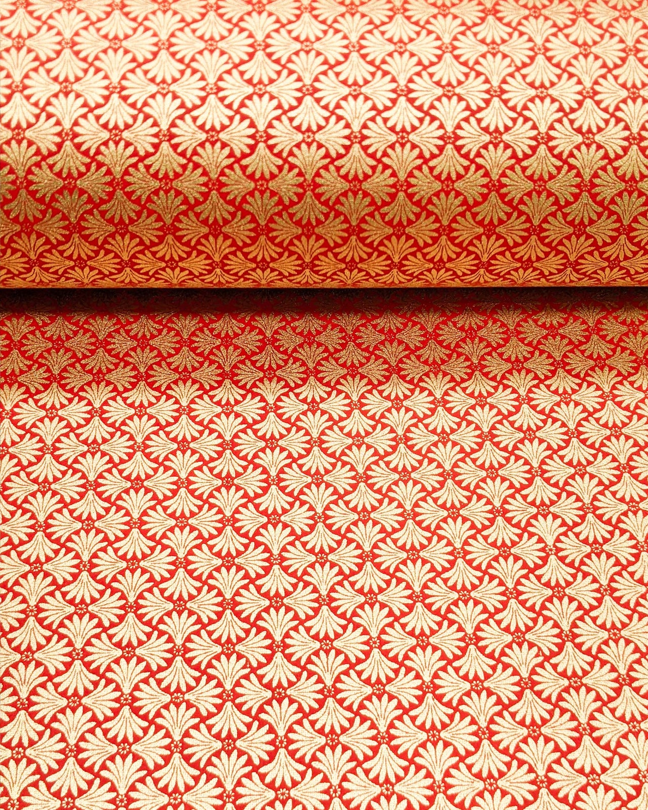 Japanese chiyogami paper featuring metallic gold geometric stylized flowers on a red background.