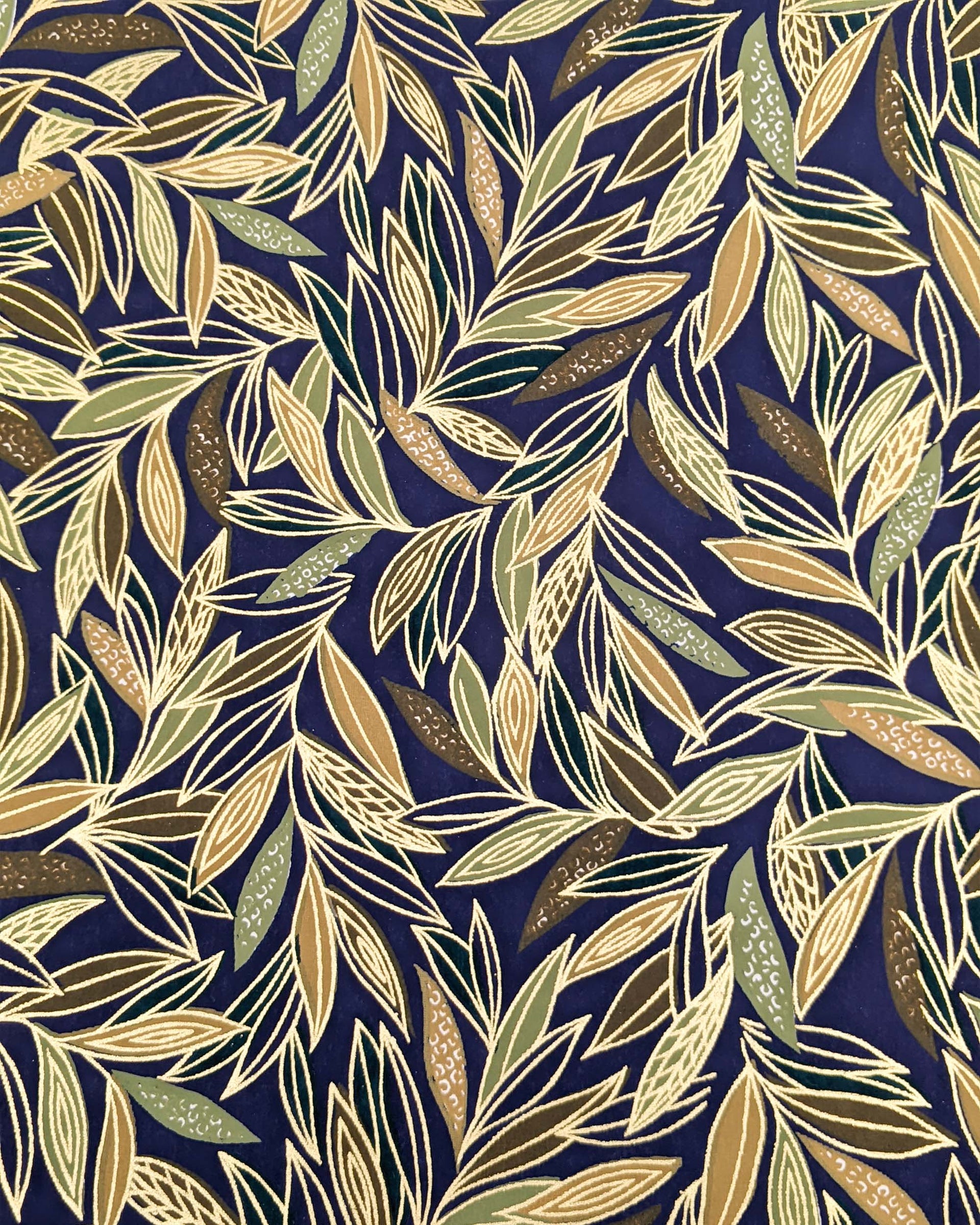 Japanese chiyogami paper featuring thin brown and green leaves on a dark blue (almost black) background with metallic gold details.