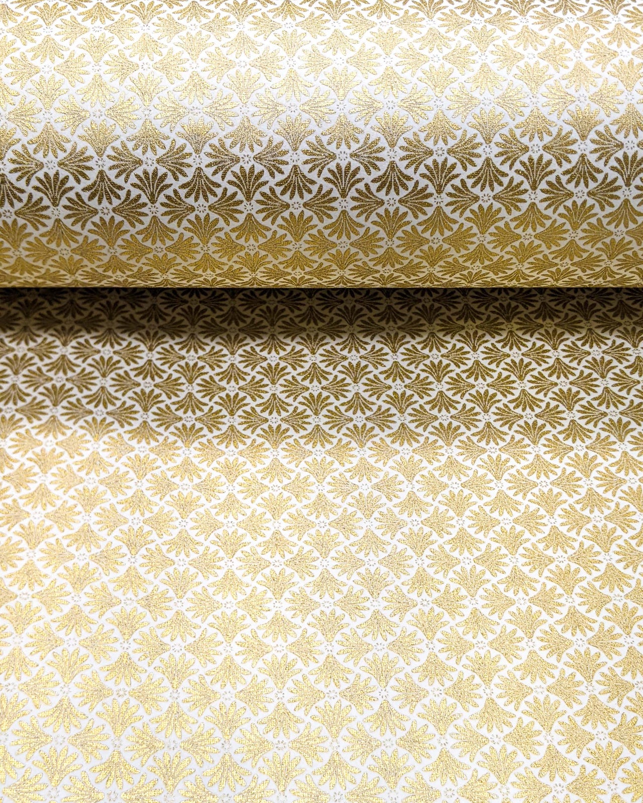 Japanese chiyogami paper featuring metallic gold geometric stylized flowers on a white background.