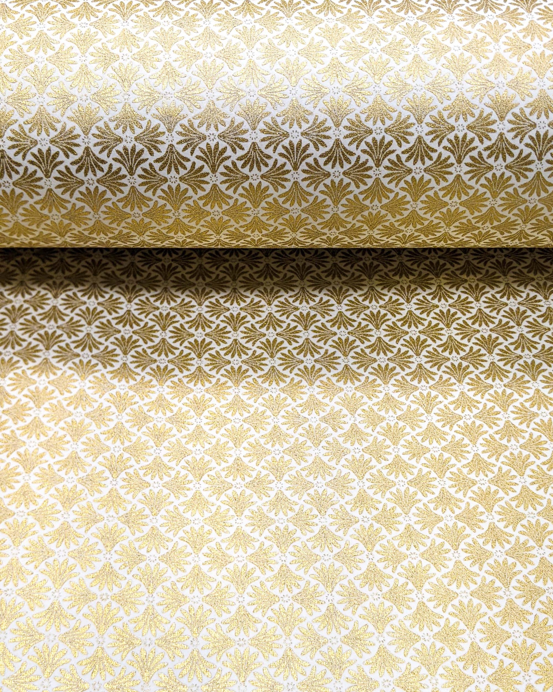 Japanese chiyogami paper featuring metallic gold geometric stylized flowers on a white background.