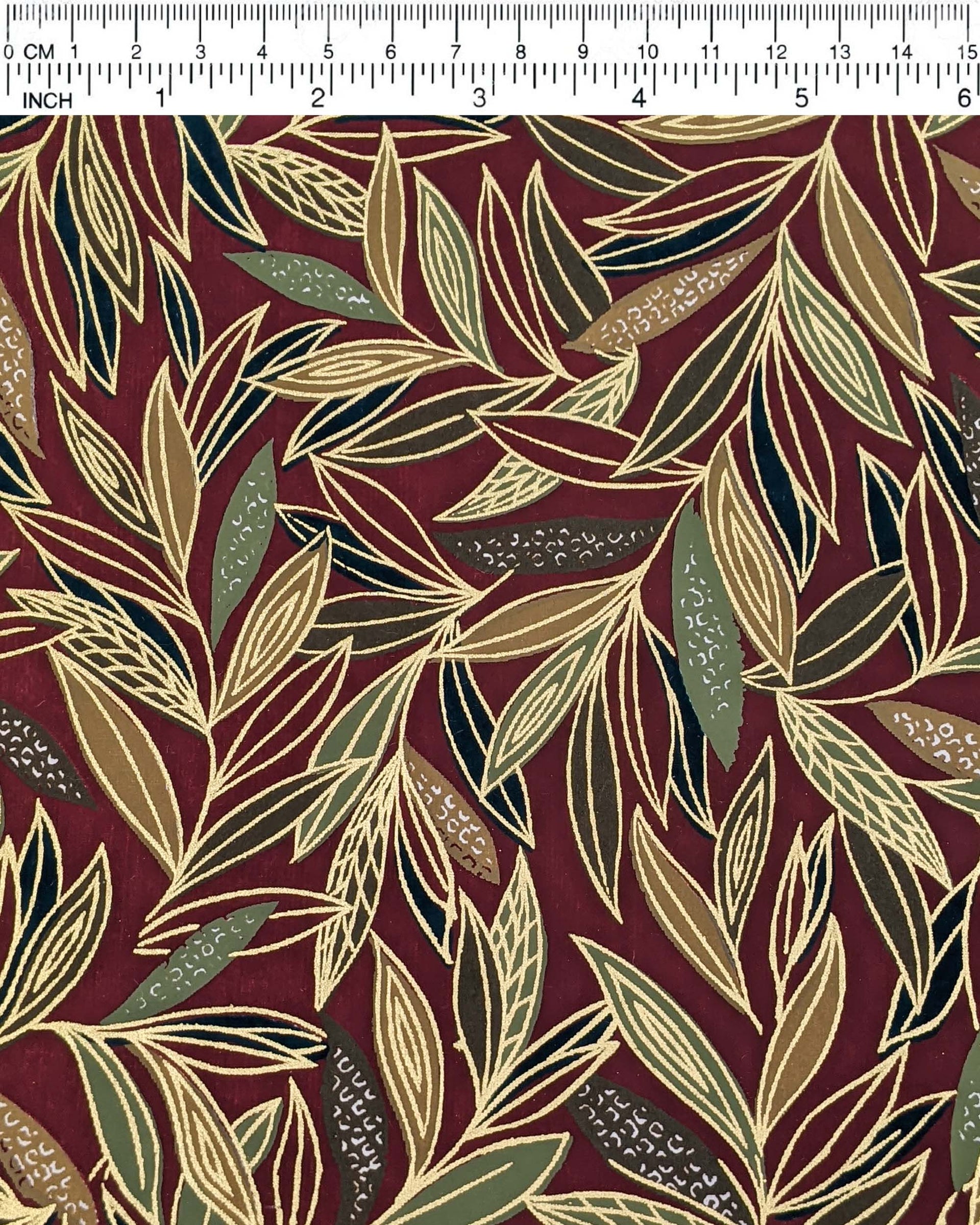 Japanese chiyogami paper featuring thin brown and green leaves on a brown background with metallic gold details.